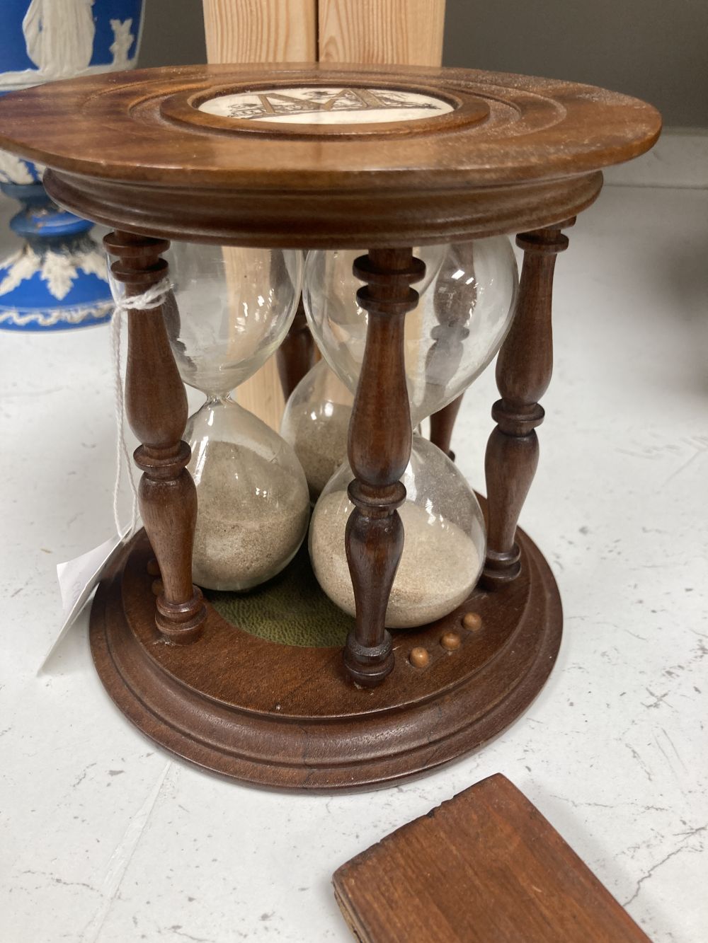 A stereoscope viewer with slides and a sand timer